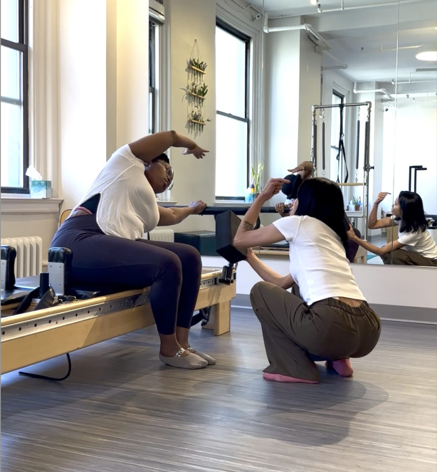 woman receiving instruction during a session at Dynamic Body Pilates near Union Square NYC